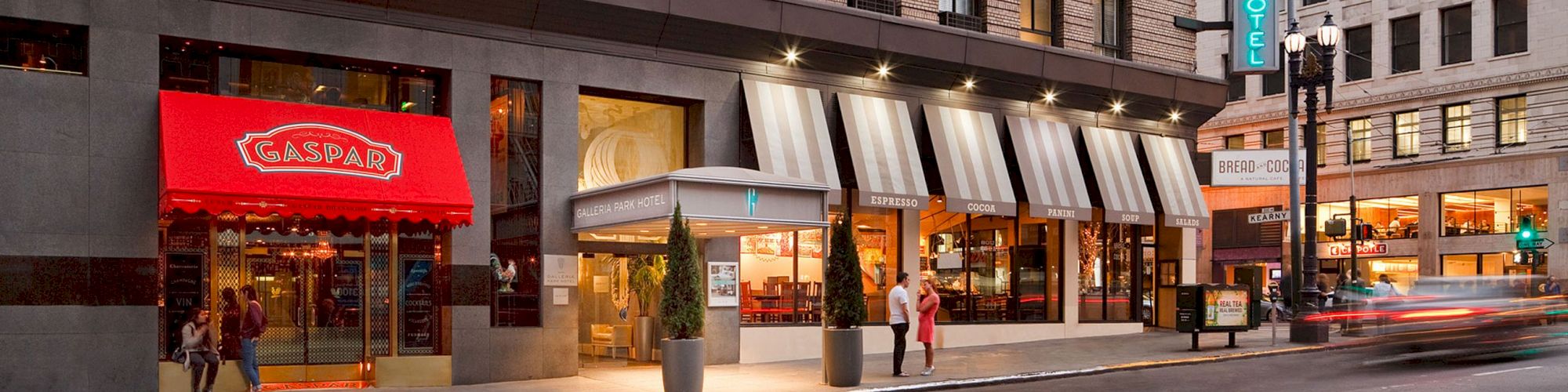 The image shows a city street with a red-awning entrance for 