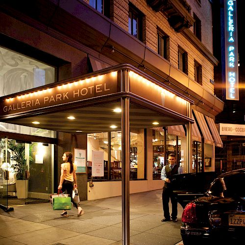 A hotel entrance at night, labeled 