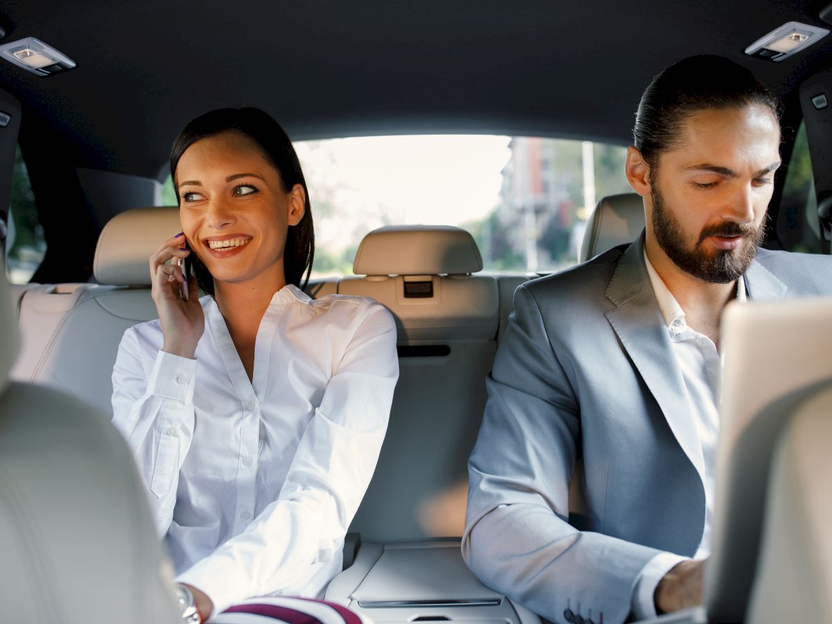 man and woman working in car