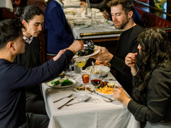 a group of men and women enjoying the dining experience at Le Parc Bistro
