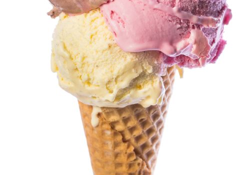 A waffle cone holds three ice cream scoops: chocolate, strawberry, and vanilla, stacked neatly on top of each other.